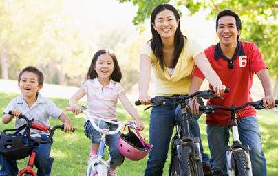 Family on bikes outdoors smiling